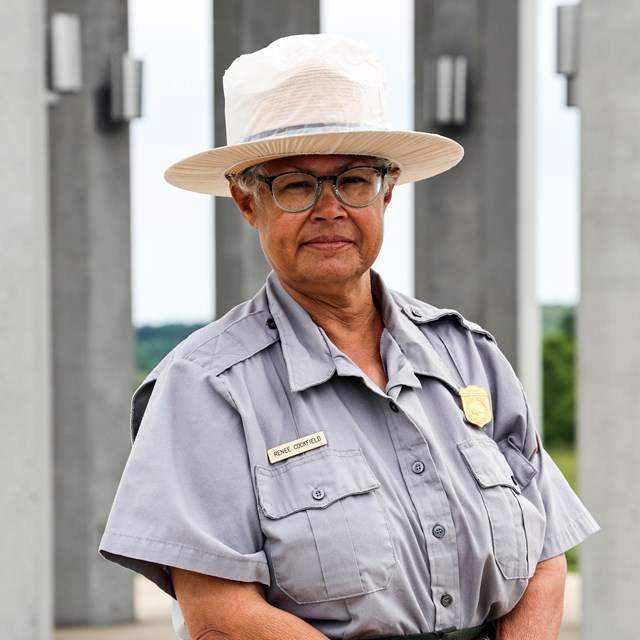 A park ranger posing at the Tower of Voices.