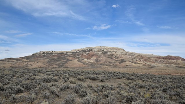 A ridge with a higher section that looks like a butte with a flat top and steep sides.