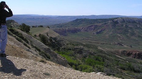 hiker looking at landscape of valleys and ridges from Cundick Ridge overlook