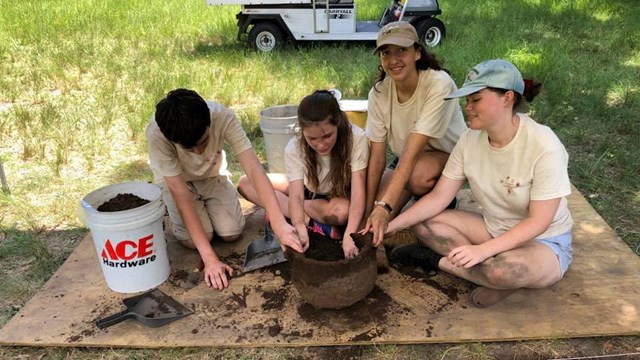 Kids digging up Artifacts at the park