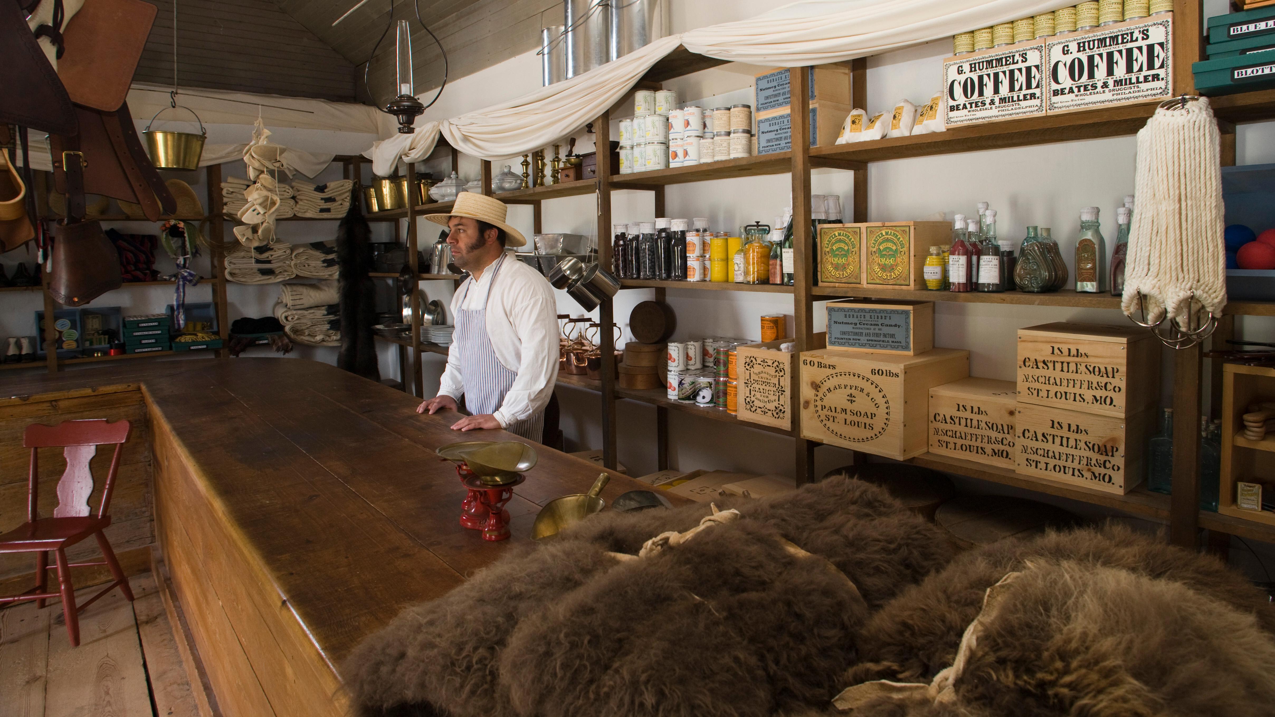 A man dressed as store clerk in a historic building