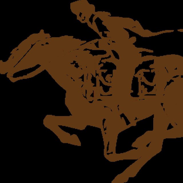 Man riding on a horse going very fast 