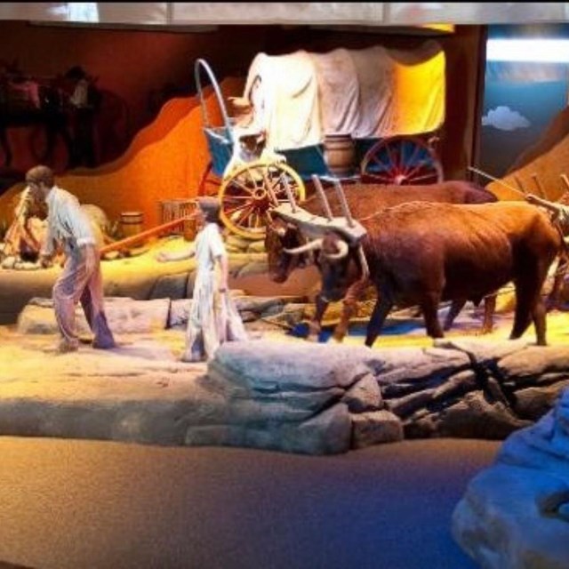 A museum exhibit with life size representations of people on the Oregon Trail. 