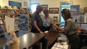 Visitors getting information from a ranger in the Visitor Center.