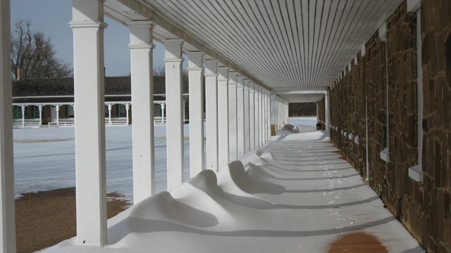 Snow on the front porch of the barracks building.