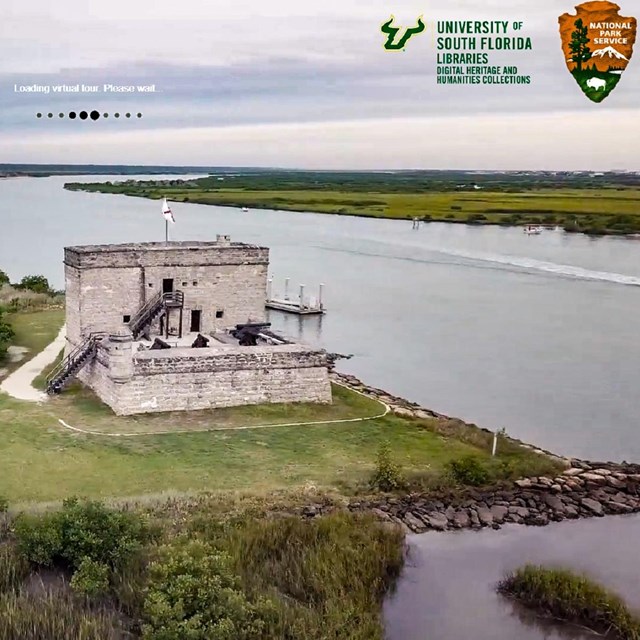 The fort from a drone with river around it and USF/NPS in text upon the image.