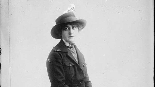 A black and white photograph of Mary A. Hickey on a bench.