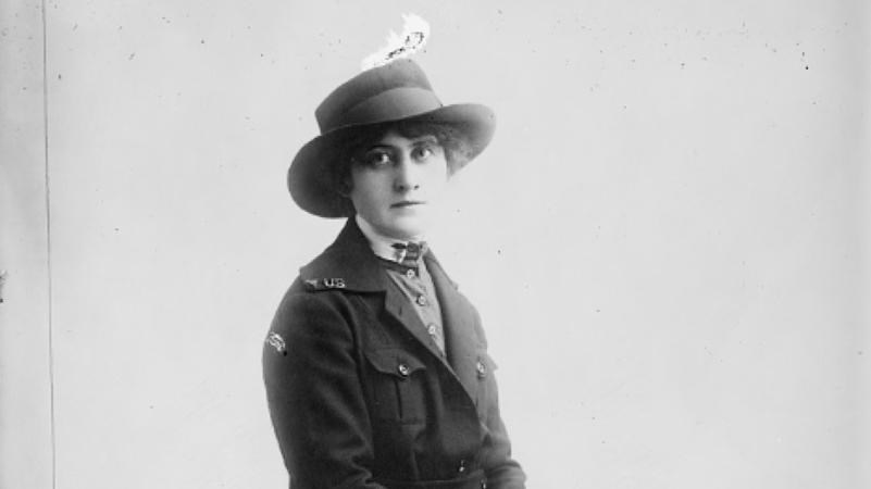 A black and white photograph of Mary A. Hickey on a bench.