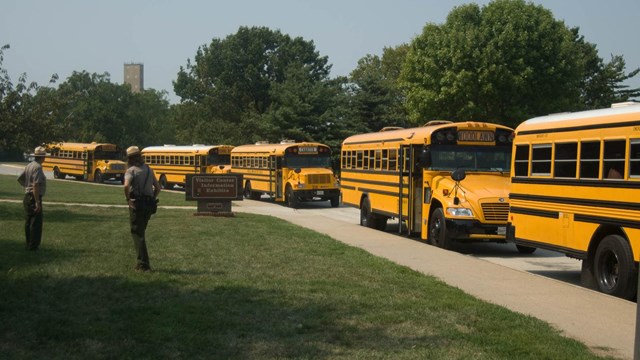 Rangers outside welcoming several school busses.