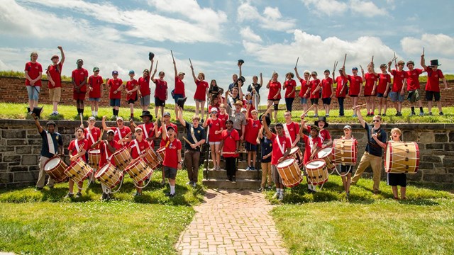 a group of Fife and Drum campers posing for a picture in Fort McHenry