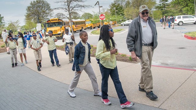 Park volunteer welcoming students at Visitor Center