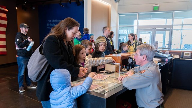 A park ranger answering visitor questions in the visitor center.