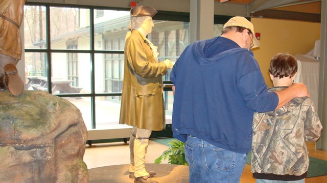 Father and son working on Jr. Ranger Program in exhibit area