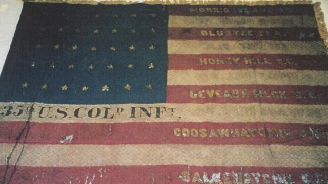 A US Flag with the 3th U.S. Col Inf in the white stripe below the blue area