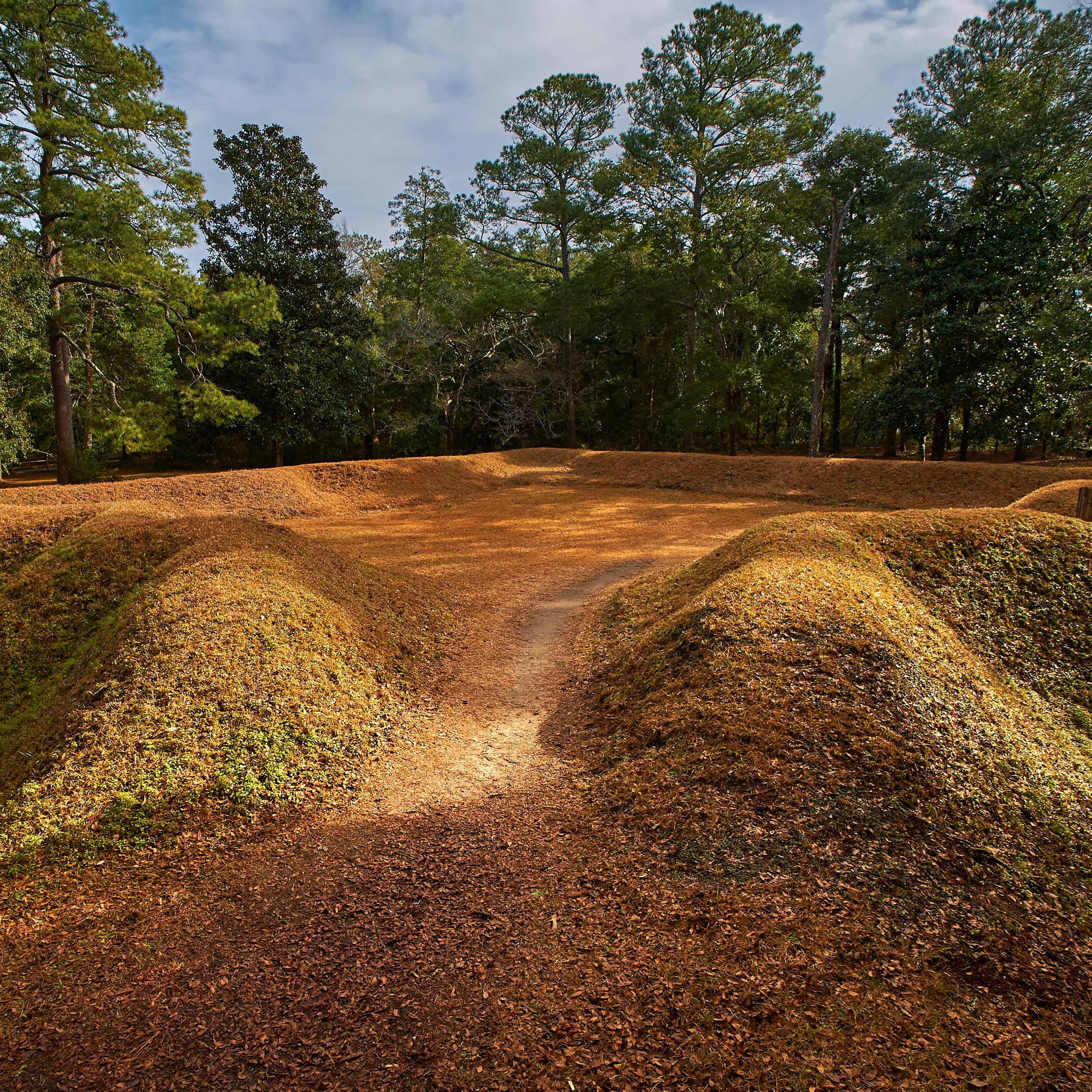 Reconstructed earthen fort covered in grass