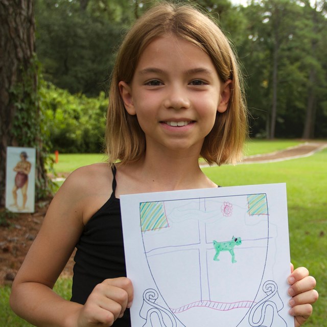 Child with coat of arms drawing