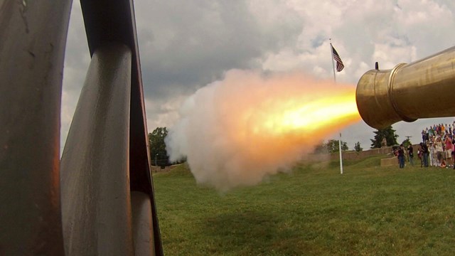 a wagon wheel on left, firing canon on right