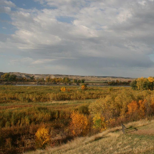 Fall colors and landscape beyond wooden post of fort