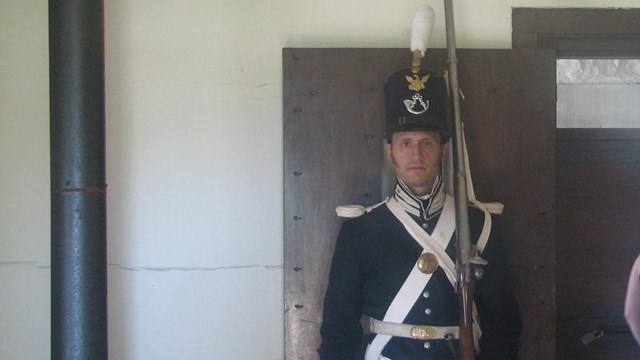 Soldier in dress clothing with tall shako