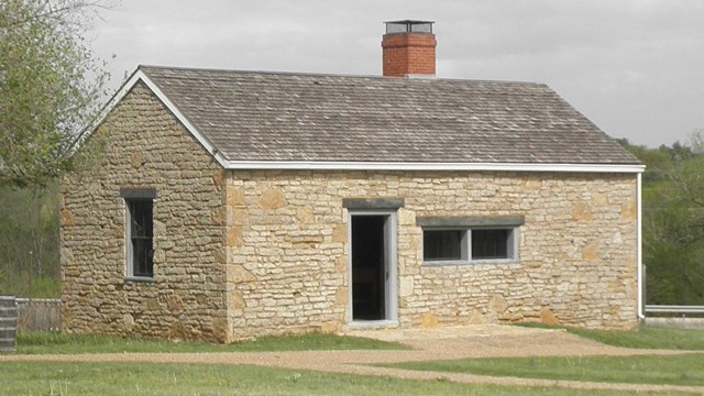 one story stone building with door and windows