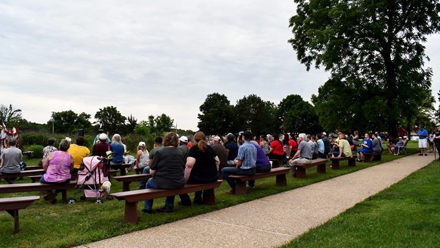 Crowd sitting and watching Native American Dancers