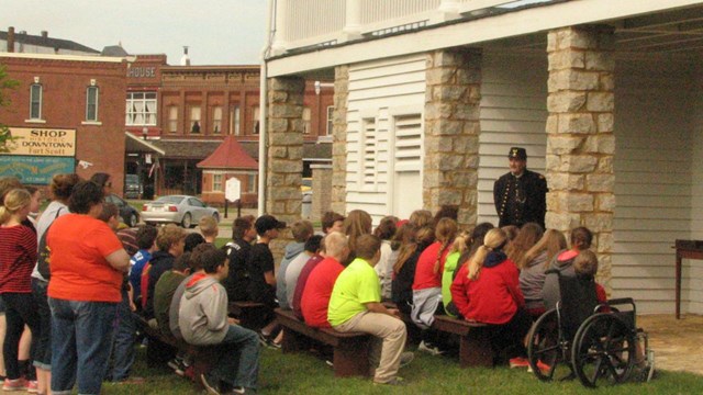 Group of people gathered around a Civil War surgeon