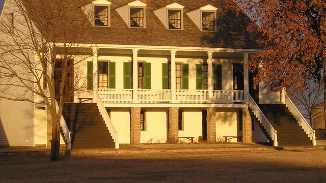 two story building with stairs on each side viewed from an angle