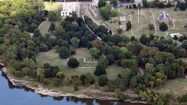 Aerial photo of Arkansas River, first fort foundation, commissary, visitor center, and gallows.