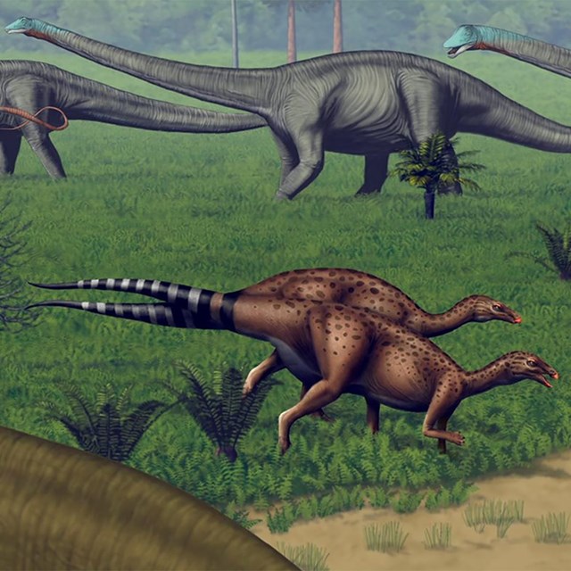 mural of small and large dinosaurs walking