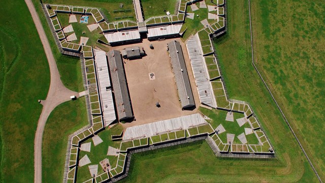 A 4-point, star-shaped wooden structure as seen from above.