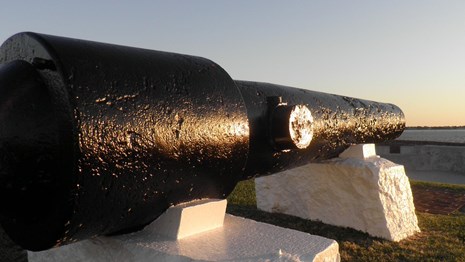 Large Civil War cannon on top of Fort Sumter with sunrise in the background