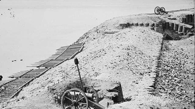 Photograph of two mountain howitzers on Fort Sumter's parapet with harbor in background