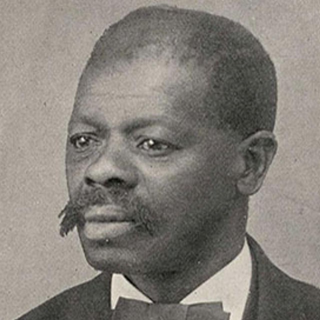 Jacob Stoyer, a black man wearing a jacket, shirt, and bow tie.