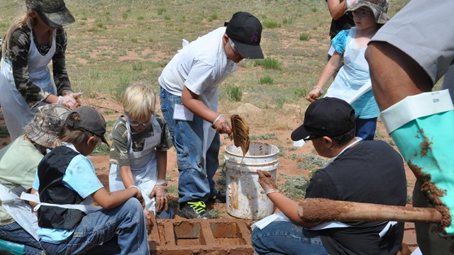 Children making adobe bricks