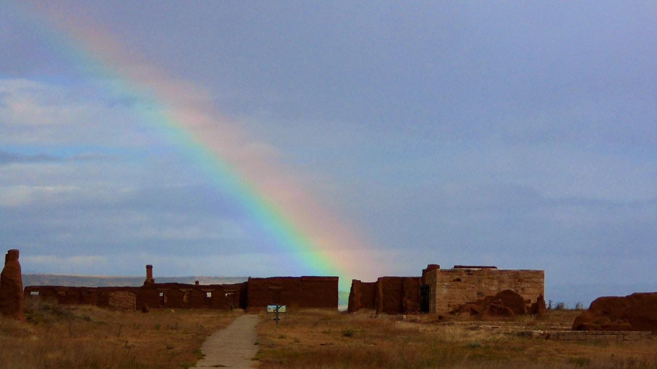 adobe buildings with rainbow in background