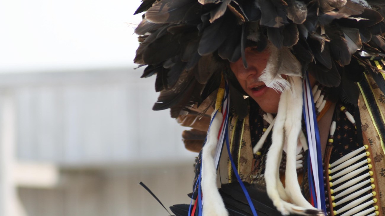 Man in traditional American Indian Dress Dancing.