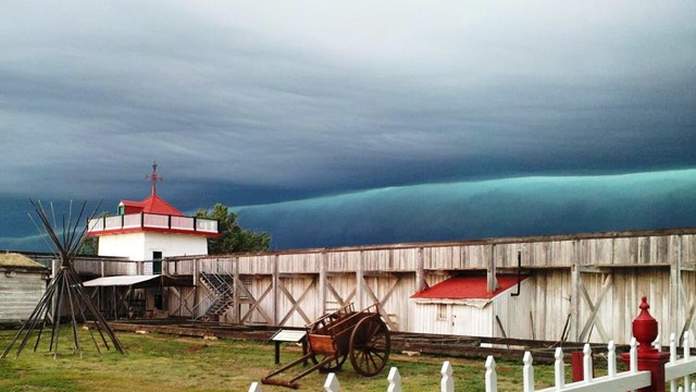 Dark blue storm cloud visible behind Fort Union southwest bastion.