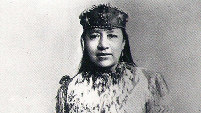 A black and white photo of a Native American woman.