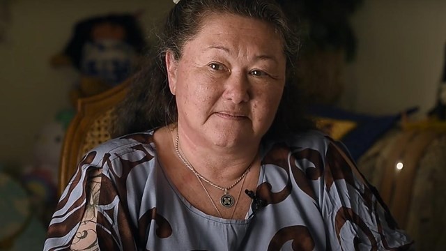 An image of a woman sitting indoors.