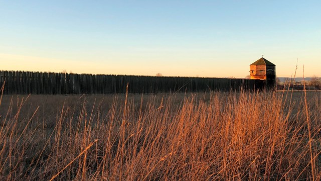 Fort Vancouver and a field at sunrise.