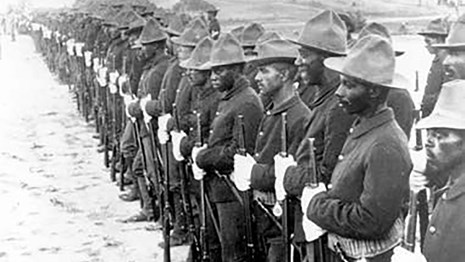 Photo of Black men in army uniforms standing in formation.