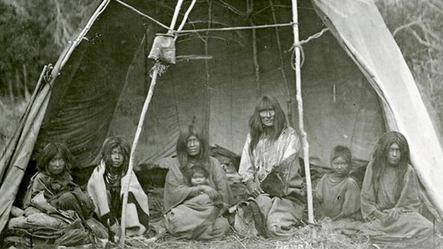 A black and white photo of a Native American family.