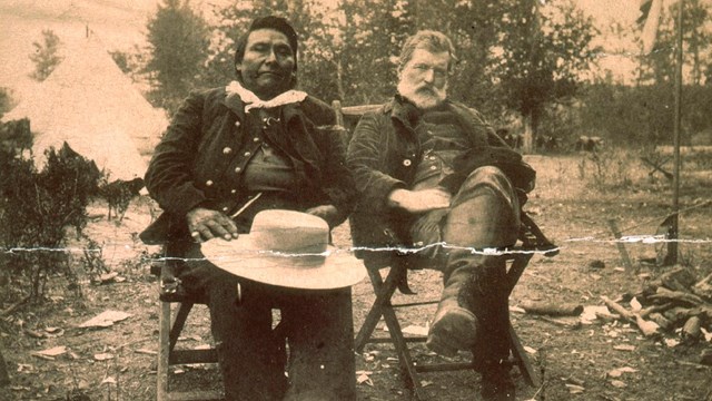 A photo of Chief Joseph and John Gibbon sitting outdoors.