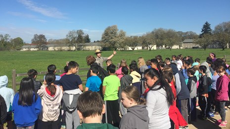A national park ranger talking to a group of students.