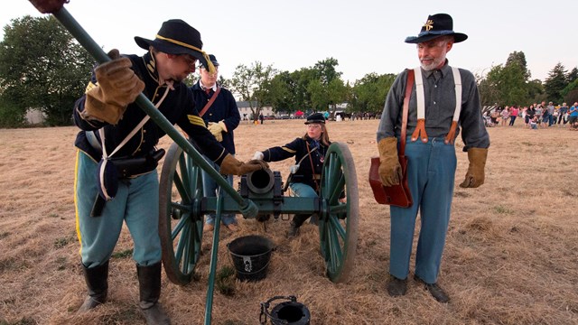 Renactors help visitore explore Vancouver Barracks during canon firing demonstration