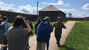 A park ranger leading a group of people through Fort Vancouver.