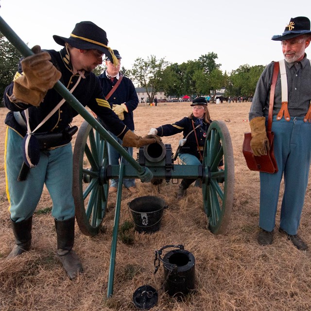 Renactors help visitore explore Vancouver Barracks during canon firing demonstration