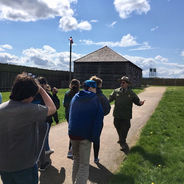 A park ranger leading a group of people through Fort Vancouver.
