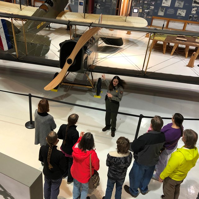 A park ranger with a group of visitors inside Pearson Air Museum