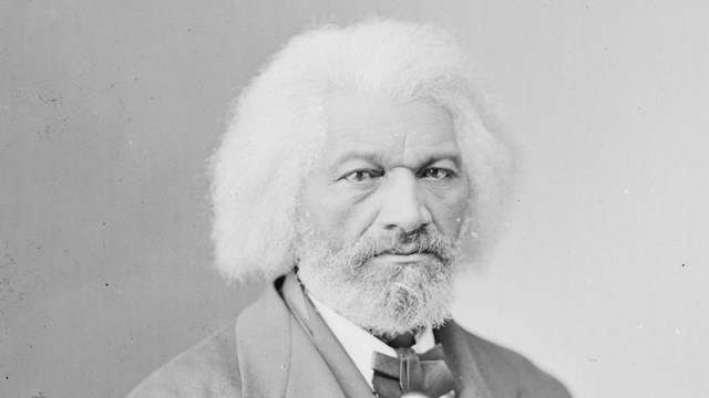 A black-and-white photograph of Frederick Douglass in his sixties